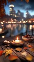 A candle and some nuts are on a table near a river photo