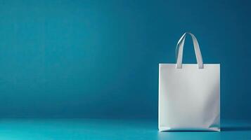 White shopping bag on blue background photo