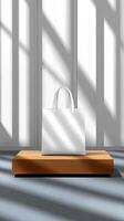 White bag on wooden shelf in front of window photo