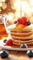 A stack of pancakes with syrup and berries photo