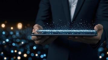 A man in a suit holding a tablet with glowing lights photo