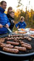 A man and a woman cooking sausages on a grill photo