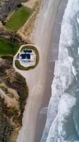 An aerial view of a house on the beach photo