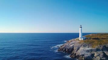 A lighthouse on a rocky cliff overlooking the ocean photo
