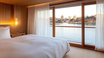 A bedroom with a view of the water and a bed photo