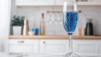 A blue champagne glass with a blue liquid inside photo
