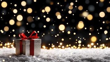 Christmas gift box on snow background with bokeh lights photo