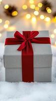 A gift box with a red ribbon and a bow photo