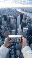 A person holding up a smartphone with a view of a city photo