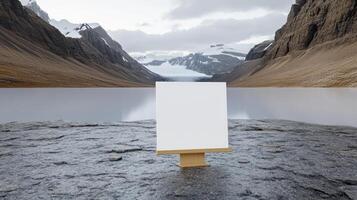 Blank canvas on the rock with mountains in the background photo