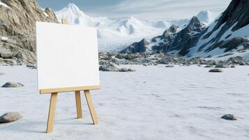 An easel with a blank canvas in front of a snowy mountain photo