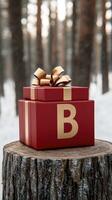 A red gift box with a golden bow sitting on a stump photo