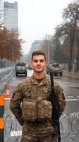A soldier standing in front of a fence photo