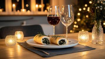 A plate with two wine glasses and a roll of meat photo