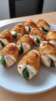 A plate of chicken wrapped in cheese and spinach photo