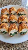 A plate of chicken and spinach stuffed with cheese photo