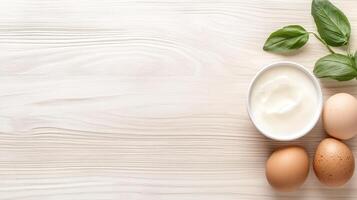 Eggs, basil and yogurt on a wooden table photo