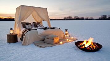 A bed with a canopy and candles on the snow photo
