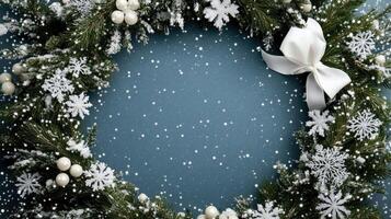 Christmas wreath with snowflakes and berries on blue background photo