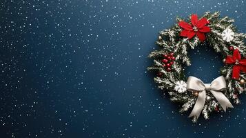 Christmas wreath on blue background with snowflakes photo
