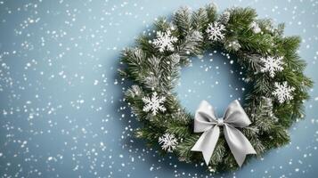 Christmas wreath with snowflakes on blue background photo