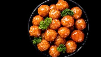 A bowl of fried chicken balls on a black background photo