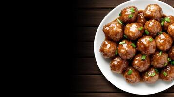 A plate of meatballs on a wooden table photo