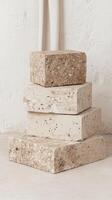 A stack of stone blocks sitting on top of a white wall photo