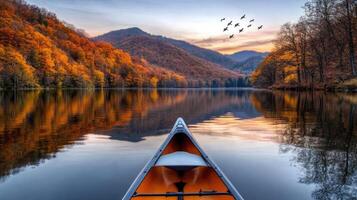 A canoe is on the water in the middle of a lake photo