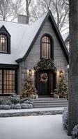 A beautiful home with a large front porch and a wreath on the door photo