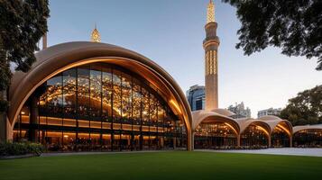 The mosque is lit up at night with a large building photo