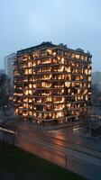 A building with many windows lit up at night photo