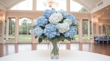 A vase of blue flowers sits on a table in a large room photo