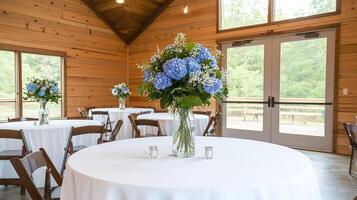 A wedding reception room with tables and chairs photo