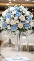 A vase filled with blue and white flowers photo