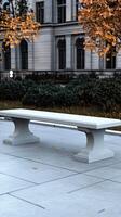 A white bench sitting on a concrete floor photo