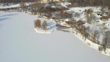 An island on a lake with a bridge in the winter Loshitsky Park.Minsk, BelarusAn island on a lake with a bridge in the winter Loshitsky Park.Minsk, Belarus video