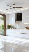 A modern kitchen with white cabinets and a ceiling fan photo