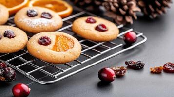 Cookies with cranberries and orange slices on a cooling rack photo