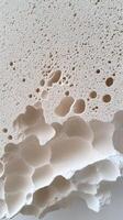 A close up of a white foam with holes photo