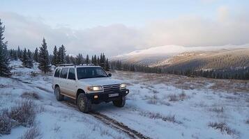 A white suv driving on a snowy road photo