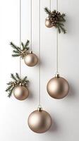 Three golden christmas balls hanging from a white wall photo