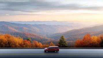 Automobile on the road in autumn with mountains in the background photo