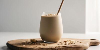 Banana peanut smoothie with oats on wooden board. photo
