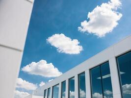 A view of a building with windows and clouds photo