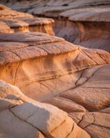 Abstract representation of sandstone textures in warm colors from a canyon in early morning light photo