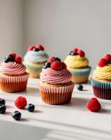 Colorful cupcakes with unique frosting and fresh berries create delightful treat photo