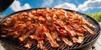 A large grill with bacon cooking on it photo