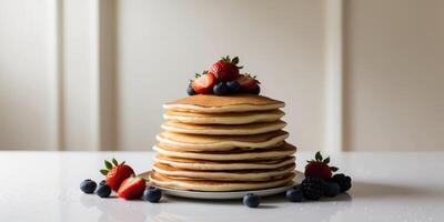 Stack of pancakes with berries and strawberries photo