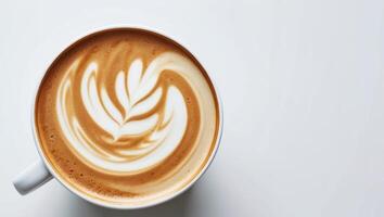 A cup of coffee with a swirl of white foam photo
